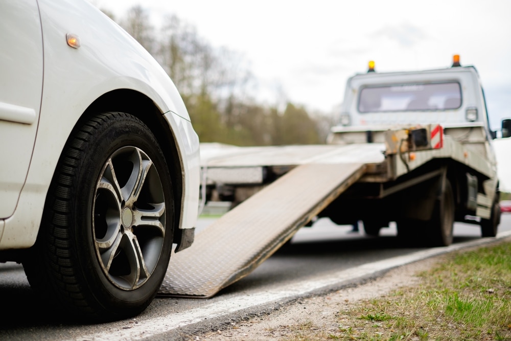 CA repo laws: car being repossessed on a truck