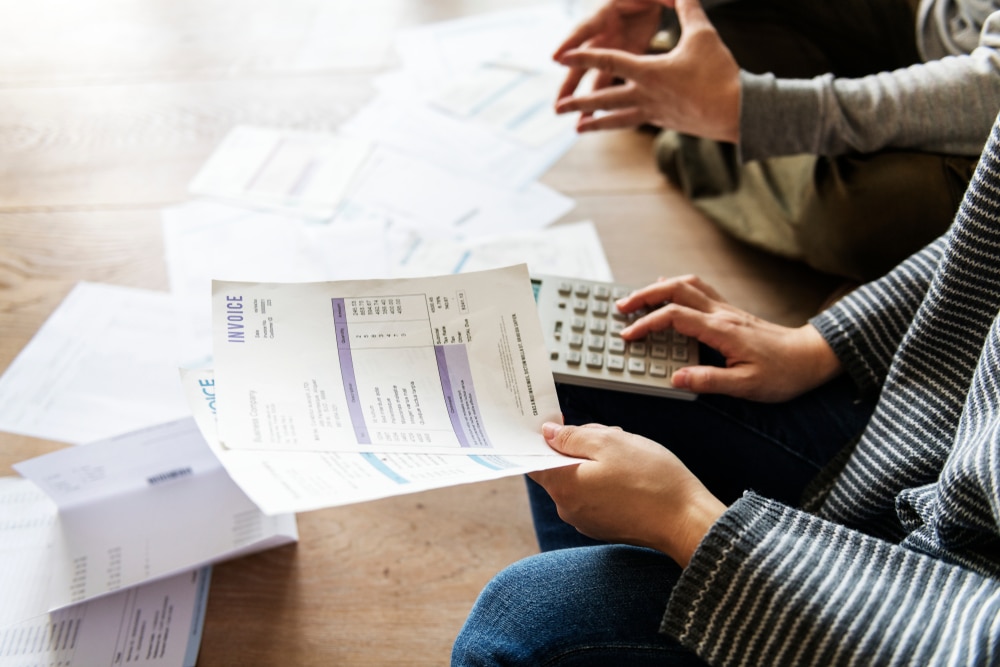 Couple sorting through debt paperwork