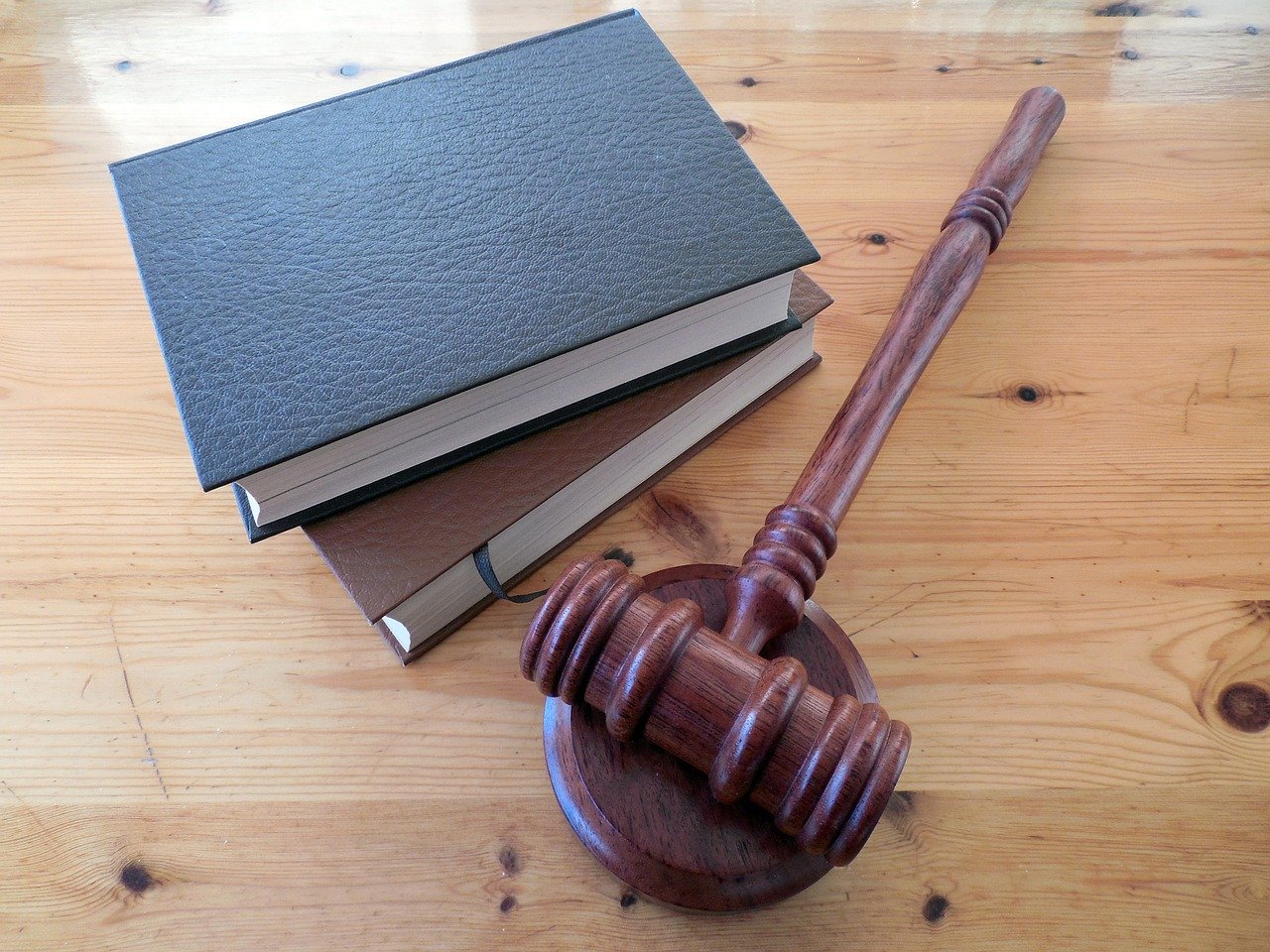 Gavel next to stacked legal books