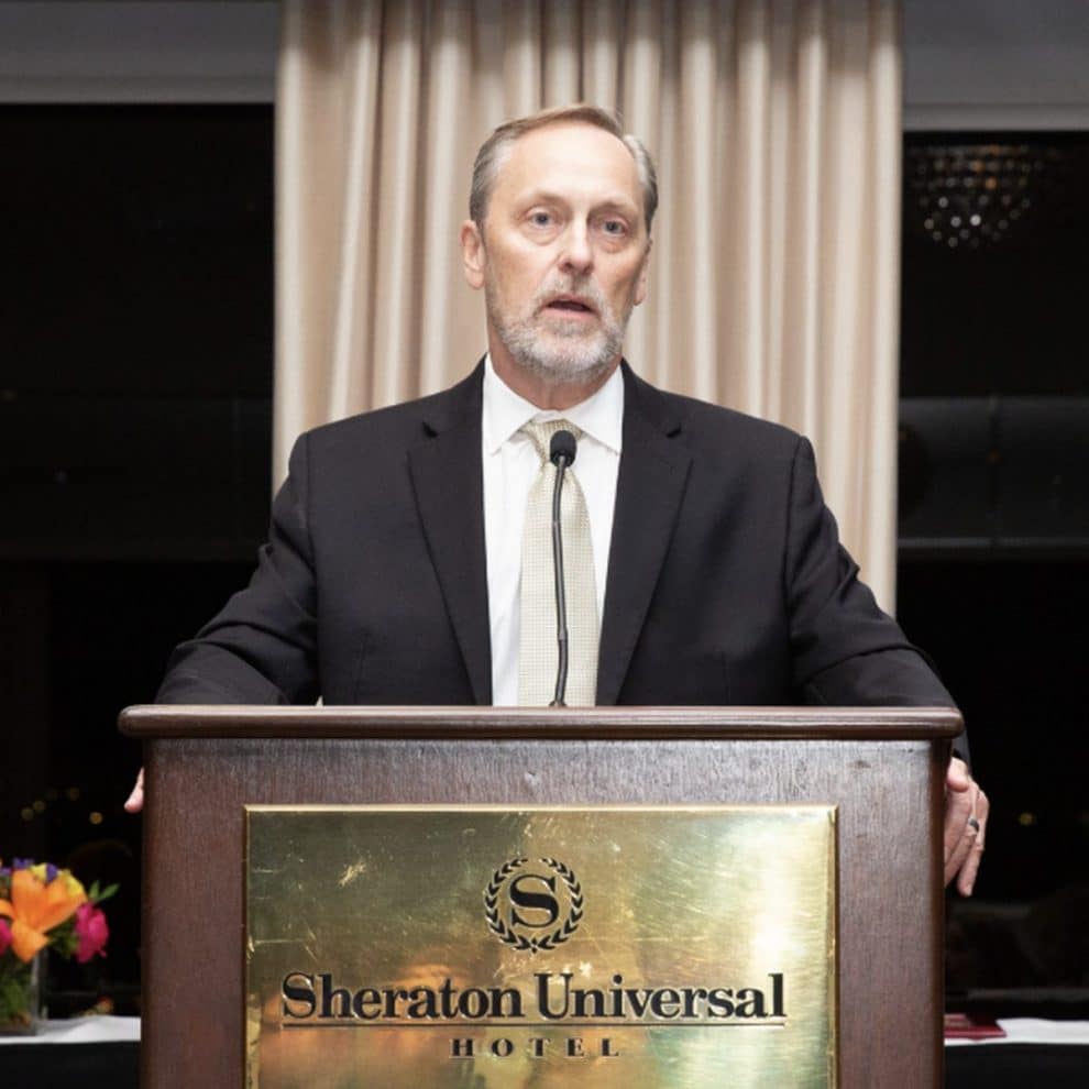 Erik Clark speaking at the podium